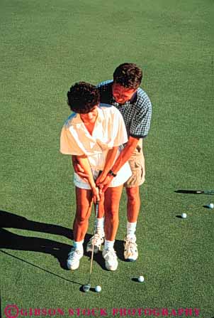 Stock Photo #3535: keywords -  affection assist close couple game golf help hug husband learn man putt recreation released sport sports teach together vert white wife woman
