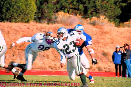 Stock Photo #19153: keywords -  ball carry carrying carrys college elude eludes eluding field fields football game games group groups high horz junior man men outdoor outdoors outside player players playing run runner runners running runs school sport sports student students team teams uniform uniforms