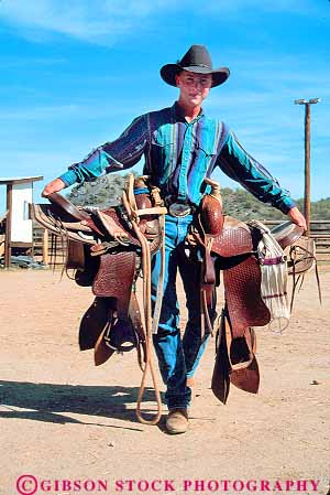 Stock Photo #17865: keywords -  arizona carrying cowboy cowboys dude equipment fun gear guest guests hand horse inn job outdoor outdoors outside play playing plays ranch ranches recreation rider riders rides riding saddle saddles southwest tac vacation vacationing vacations vert west western wickenburg work worker working works