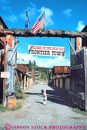 Stock Photo #18508: keywords -  child children cowboy frontier gate montana mountain old region rocky state town towns vert vintage wagon west western wheel wheels wood wooden