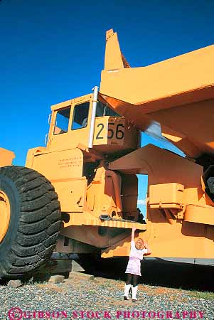 Stock Photo #18533: keywords -  artifact artifacts big butte child compare compared compares comparing comparison contrast contrasted contrasting contrasts differ difference differences different differs display displays dwarfed equipment gigantic girl heavy historic huge large little machine machinery metal mine mining montana mountain museum museums next of old opposite ore people person region released rocky samll size sized sizes standing state tiny tractor transport vert vintage west western wheel wheels world yellow