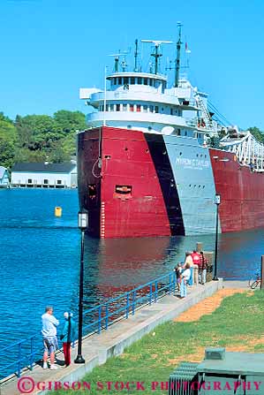 Stock Photo #19224: keywords -  against big boat boating channel channels charlevoix compare compared compares comparison contrast contrasted contrasting contrasts difference different diminuative freighter great huge industry lakes large little magnitude michigan move people region scale ship shipping ships shore shoreline size sized sizes small state through transporatation vert watching with