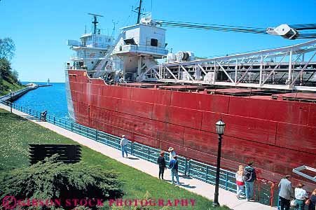 Stock Photo #19225: keywords -  against big boat boating channel channels charlevoix compare compared compares comparison contrast contrasted contrasting contrasts difference different diminuative freighter great horz huge industry lakes large little magnitude michigan moving people region scale ship shipping ships shore shoreline size sized sizes small state through transporatation watching with