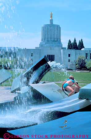 Stock Photo #18294: keywords -  attraction building buildings capitol capitols child children fountain fountains in kid kids near northwest oregon park play playing plays salem state summer tourist vert water wilson