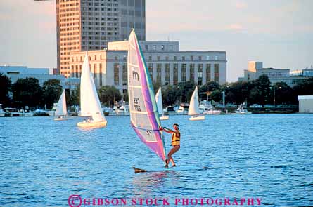 Stock Photo #19495: keywords -  acftivity activities boat boats boston charles cities city dusk england evening horz massachusetts new people person recreation region river rivers sail sailing sport state summer surf urban wind windsurfing woman