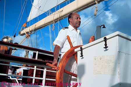 Stock Photo #15542: keywords -  african american black career ethnic ethnicity horz job jobs man men minority navigate navigates navigating navigation occupation outdoor outdoors outside people released sailor seaman ship ships steer steering steers uniform wheel work worker workers working works