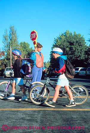 Stock Photo #16664: keywords -  bike bikes boy boys child children control cross crossing crosswalk direct direction directs elementary girl girls guard guards in kid kids near outdoor outdoors outside people person road roads safe safety school sign signs stop street streets student students traffic vert walk walking walks woman young youth