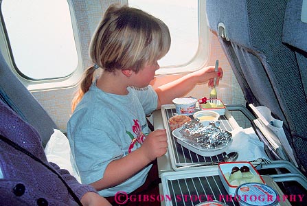 Stock Photo #16695: keywords -  airplane airplanes child children dining eat eating eats food girl girls horz indoor indoors inside kid kids meal meals passenger passengers people person plane planes released seat seated seats young youth