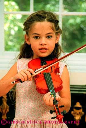 Stock Photo #2025: keywords -  child children girl girls harmon home instrument instruments kid kids lesson lessons musical musician play playing plays practice practices practicing released skill sound string stringed vert violin violins youth