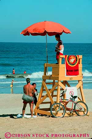 Stock Photo #17094: keywords -  atlantic authority beach beaches career coast coastal colorful elevate elevated employee guard guards in job jobs lifeguard lifeguarding lifeguards lookout occupation ocean position rescue rescuer safe safety sand sea seashore shade shore stand stands summer surf tower umbrella vert view viewing views virginia water work worker workers working