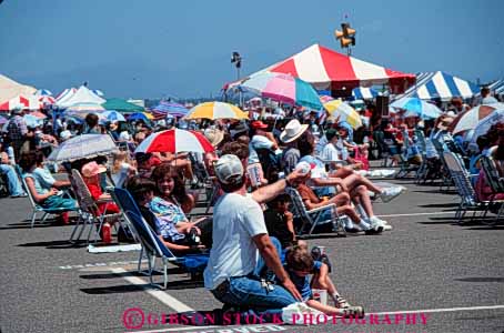 Stock Photo #4989: keywords -  air array audience crowd crowded gather gathered gathering grouped horz hot lots many multitude observe pavement people see shade show summer sun sunny together umbrella umbrellas watch